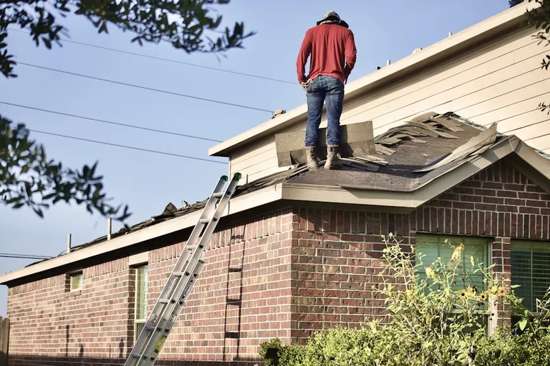 Professional roofer working on a residential roof in Sun Haven Homes